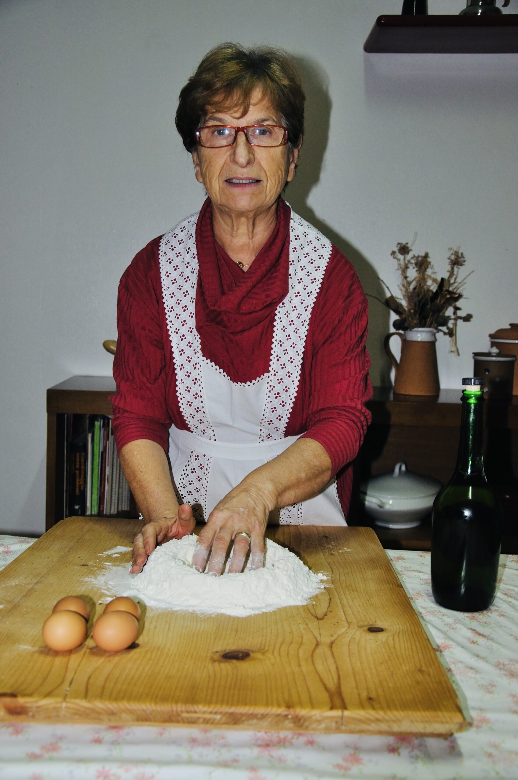 Mamma Melina formt von Hand frische Pasta auf einem Holzbrett